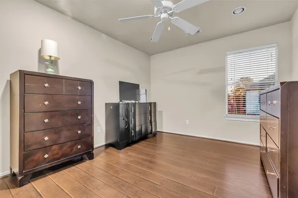 a view of empty room with cabinet and ceiling fan