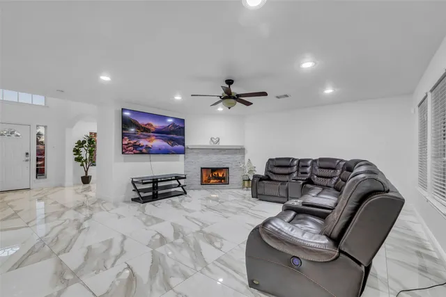 a bathroom with a granite countertop sink a toilet and a shower