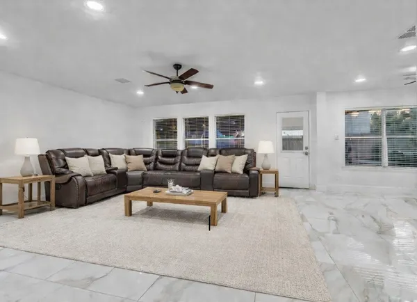 a living room with furniture and a large window