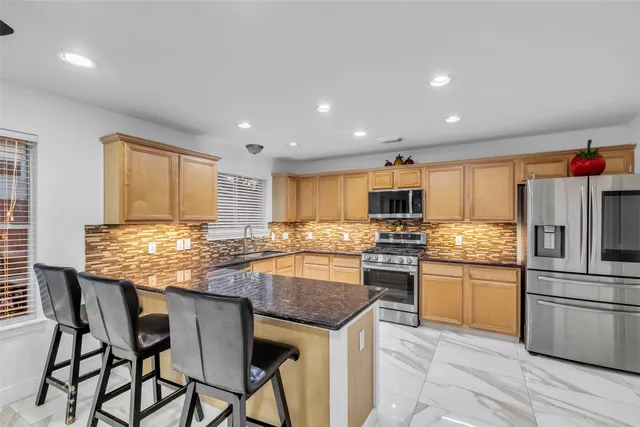 a view of backyard with outdoor seating and plants