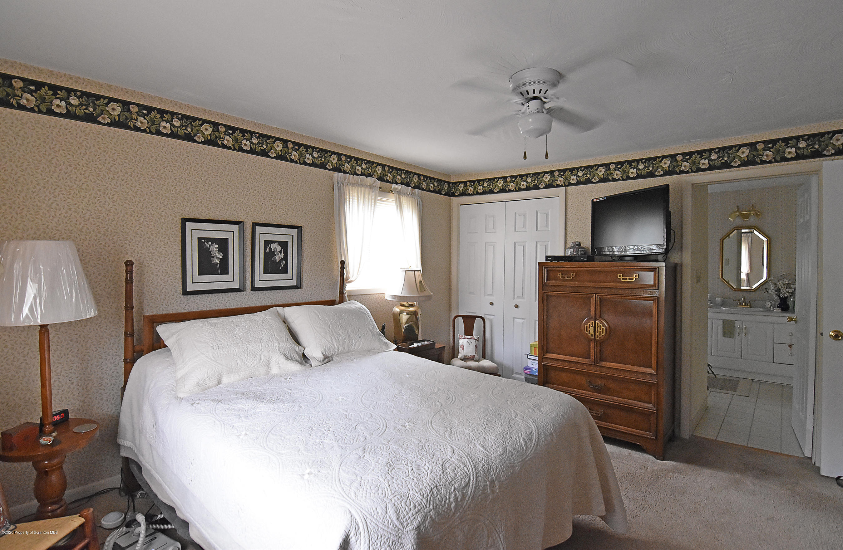 614 State Rte 1014 Nicholson, PA 18446 - Photo 11 of 23 a bedroom with a bed and a chandelier