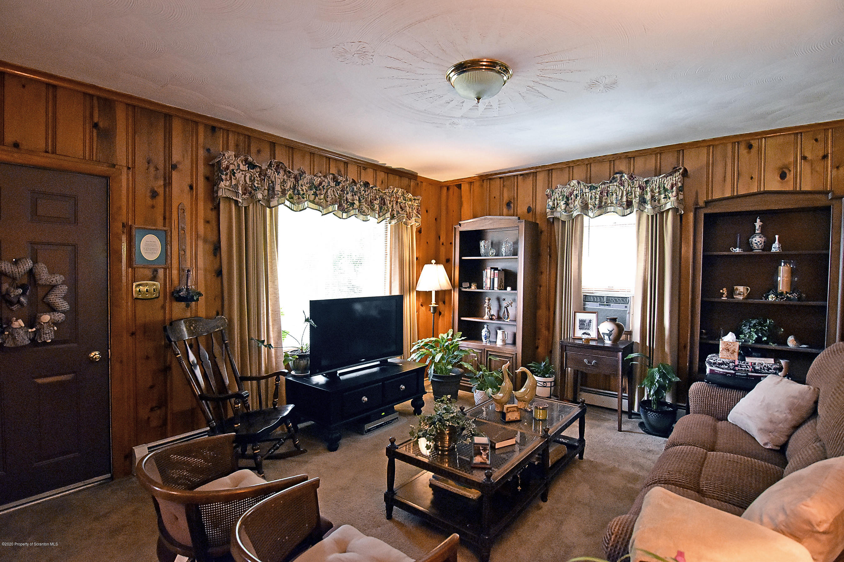 614 State Rte 1014 Nicholson, PA 18446 - Photo 10 of 23 a living room with furniture a flat screen tv and a large window