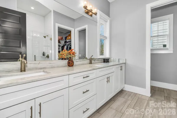 a bathroom with a sink double vanity and a mirror
