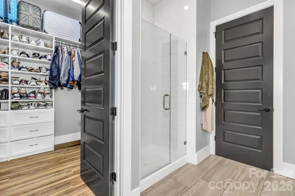 a view of walk in closet and bedroom