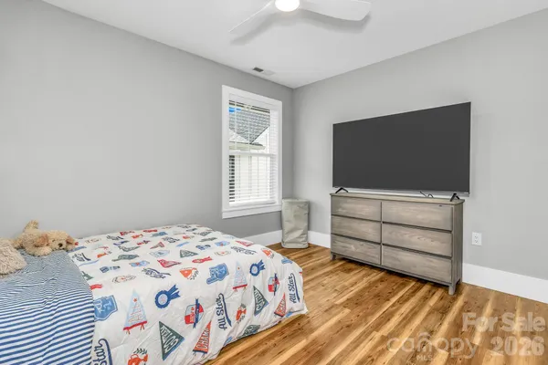 a bedroom with a bed and flat screen tv