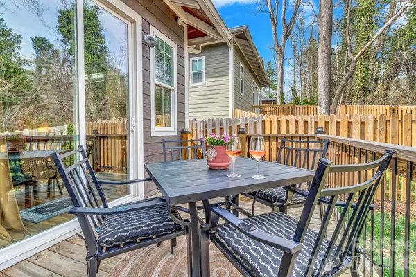 a view of a roof deck with wooden floor and fence