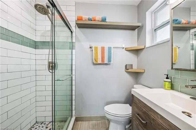 a bathroom with a toilet and a shower