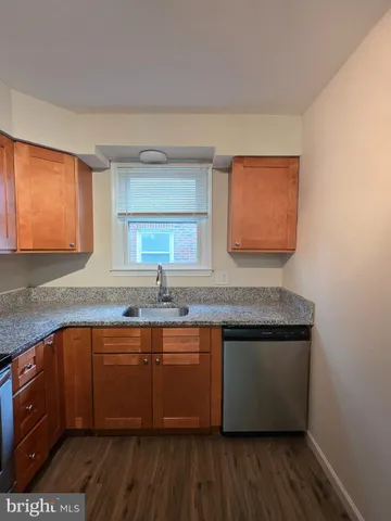 a kitchen with stainless steel appliances granite countertop a sink a stove a counter space and cabinets
