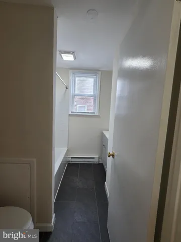 a white toilet sitting next to a shower