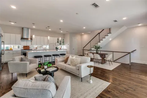 a living room with furniture and kitchen view