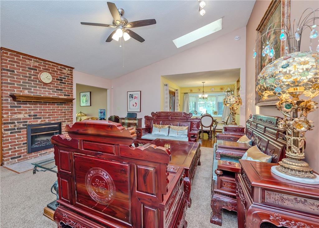 7 Old Oak Trail Hartwell, GA 30643 - Photo 11 of 59 a living room with furniture a couch and a chandelier