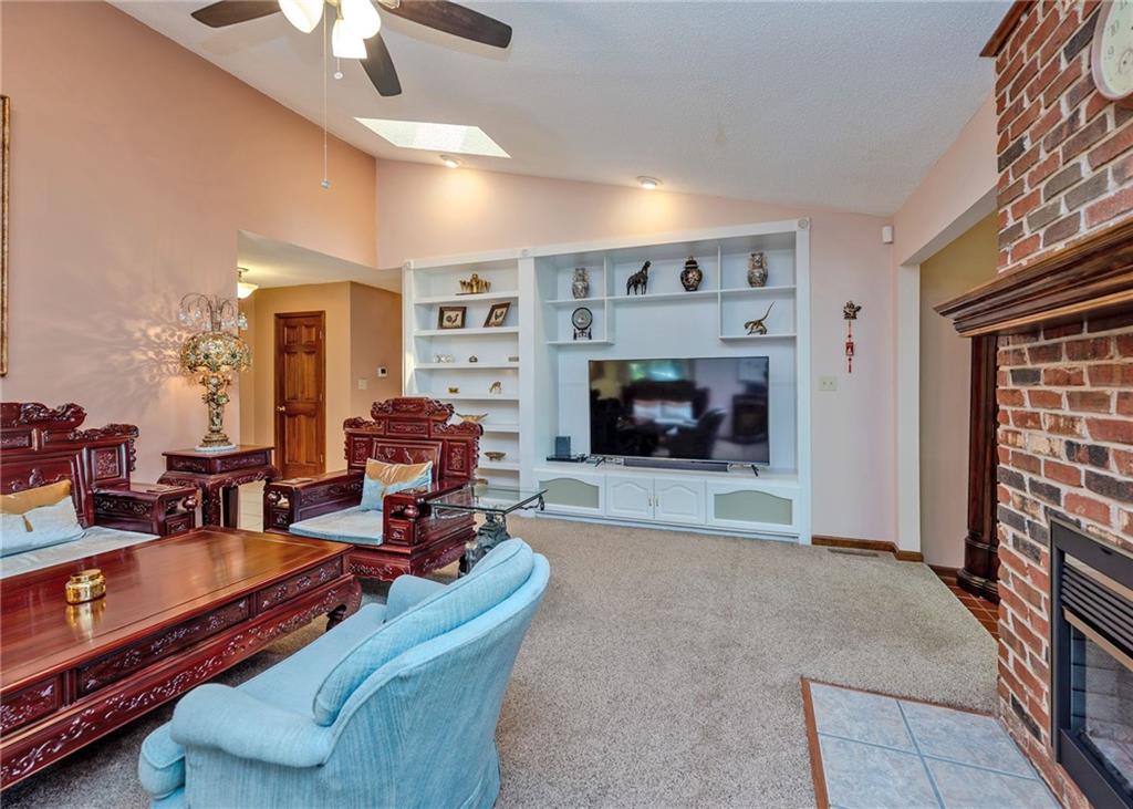 7 Old Oak Trail Hartwell, GA 30643 - Photo 13 of 59 a living room with furniture a fireplace and a flat screen tv