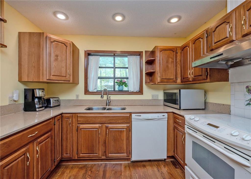 7 Old Oak Trail Hartwell, GA 30643 - Photo 14 of 59 a kitchen with a sink stove and cabinets