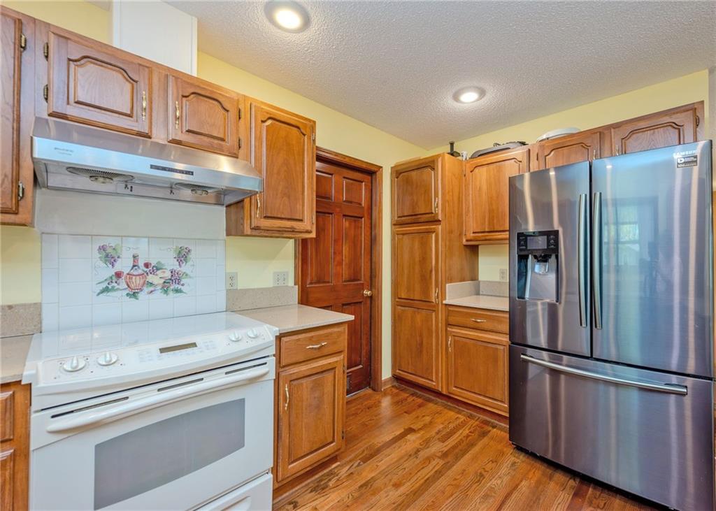 7 Old Oak Trail Hartwell, GA 30643 - Photo 15 of 59 a kitchen with stainless steel appliances a refrigerator and a stove top oven