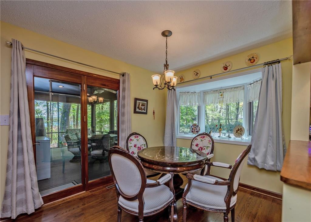 7 Old Oak Trail Hartwell, GA 30643 - Photo 16 of 59 a dining room with furniture a chandelier and wooden floor