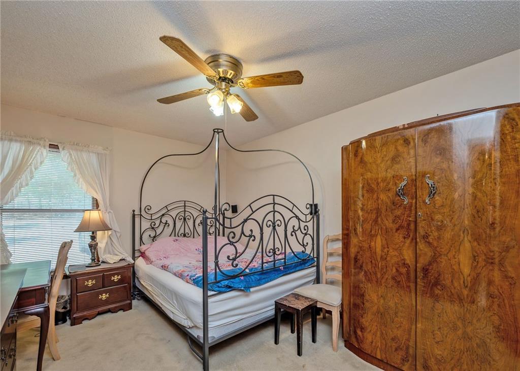 7 Old Oak Trail Hartwell, GA 30643 - Photo 23 of 59 a bedroom with a bed and a chandelier