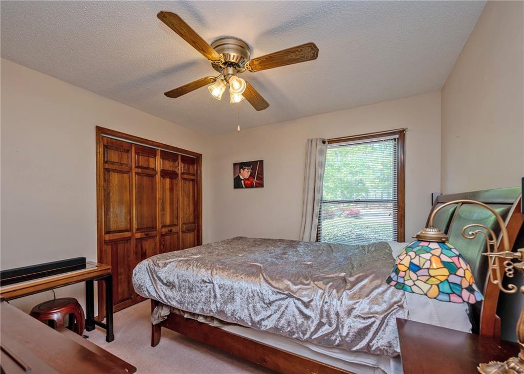 7 Old Oak Trail Hartwell, GA 30643 - Photo 24 of 59 a bedroom with a bed and ceiling fan
