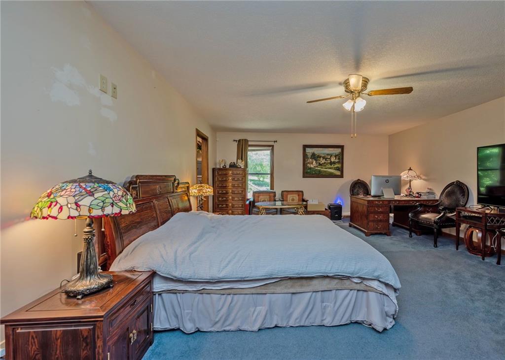 7 Old Oak Trail Hartwell, GA 30643 - Photo 25 of 59 a bed room with a bed window and a chandelier
