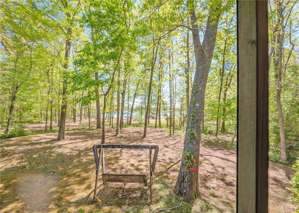 7 Old Oak Trail Hartwell, GA 30643 - Photo 31 of 59 a porch with a bench and trees
