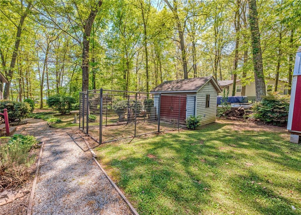 7 Old Oak Trail Hartwell, GA 30643 - Photo 39 of 59 a front view of a house with a garden and trees