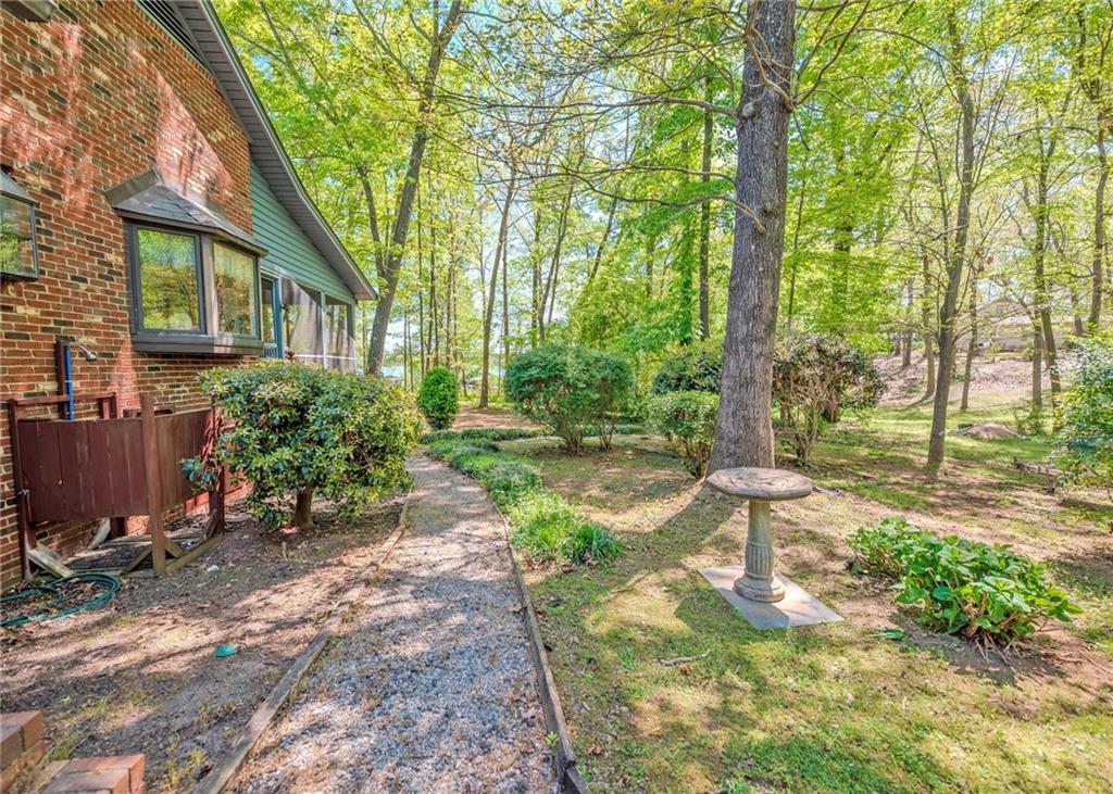 7 Old Oak Trail Hartwell, GA 30643 - Photo 40 of 59 a front view of a house with a yard and trees