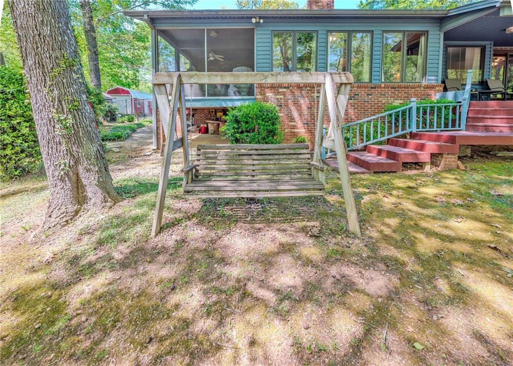 7 Old Oak Trail Hartwell, GA 30643 - Photo 43 of 59 a view of house with backyard outdoor seating and trees