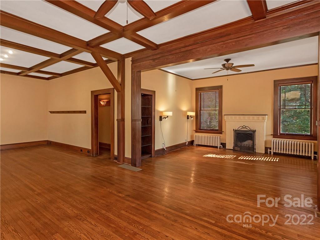 218 West Main Street Brevard, NC 28712 - Photo 21 of 48 a view of a livingroom with wooden floor and a fireplace
