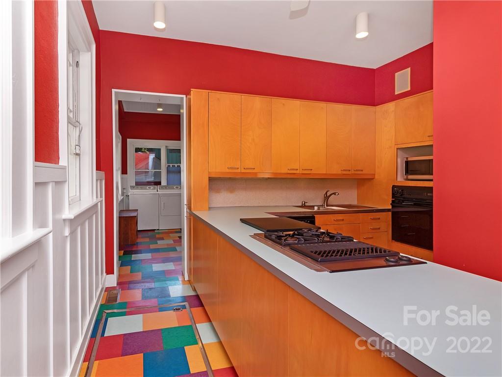 218 West Main Street Brevard, NC 28712 - Photo 24 of 48 a kitchen with stainless steel appliances a sink and a stove