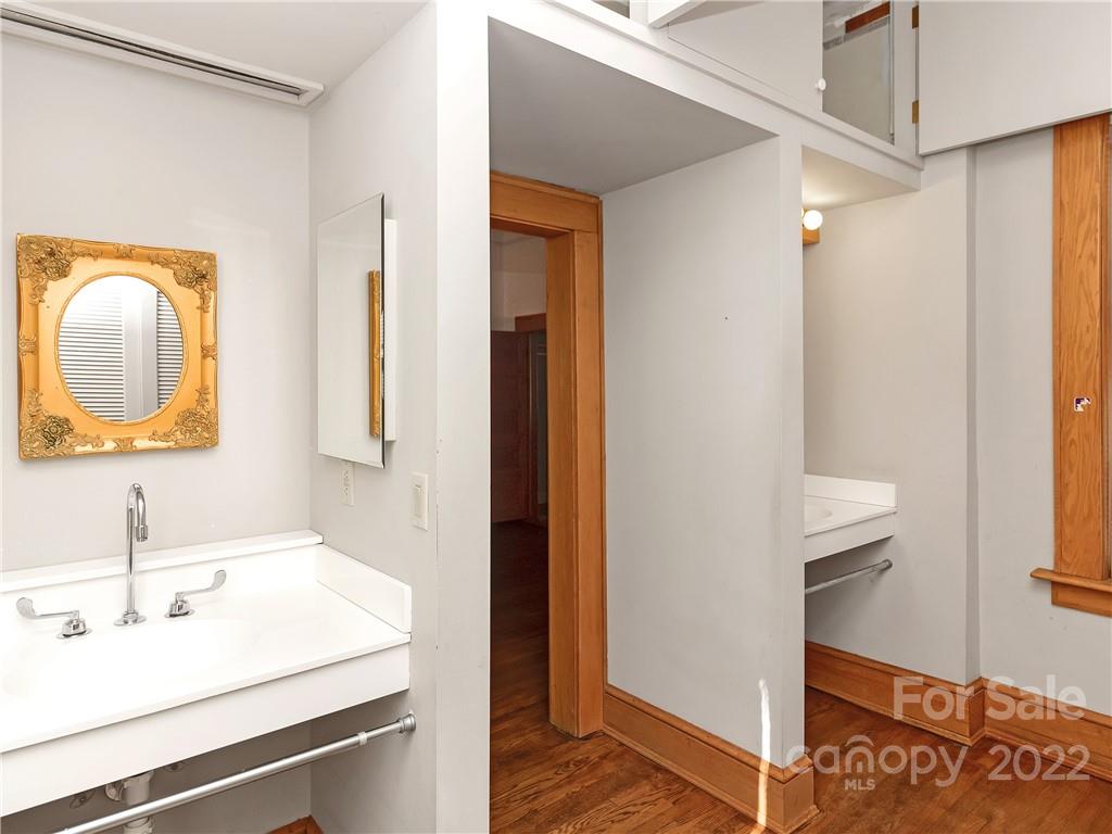 218 West Main Street Brevard, NC 28712 - Photo 32 of 48 a bathroom with a sink and a mirror