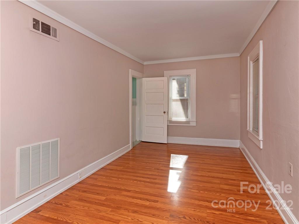 218 West Main Street Brevard, NC 28712 - Photo 38 of 48 a view of an empty room with wooden floor and a window