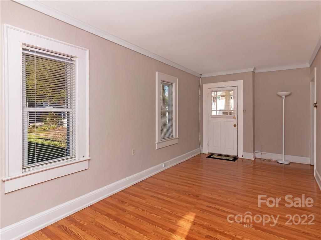 218 West Main Street Brevard, NC 28712 - Photo 39 of 48 a view of an empty room with window and wooden floor