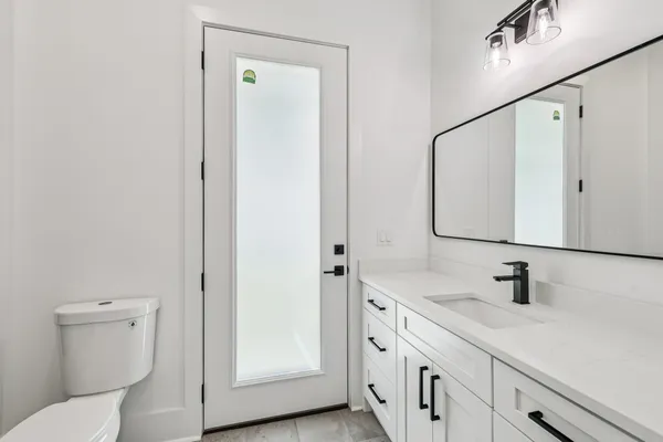 a bedroom with a bed and a ceiling fan