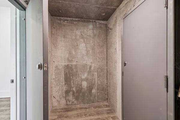 a view of walk in closet with empty racks