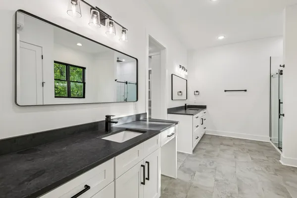 a view of a kitchen with kitchen island a sink wooden floor and a stove