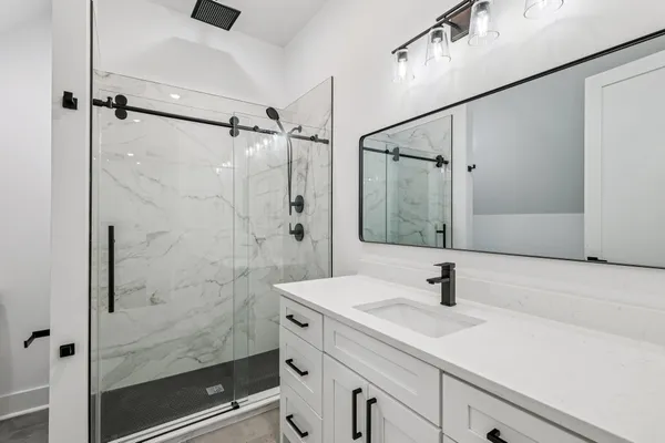 a view of an empty room with a fireplace and a large window