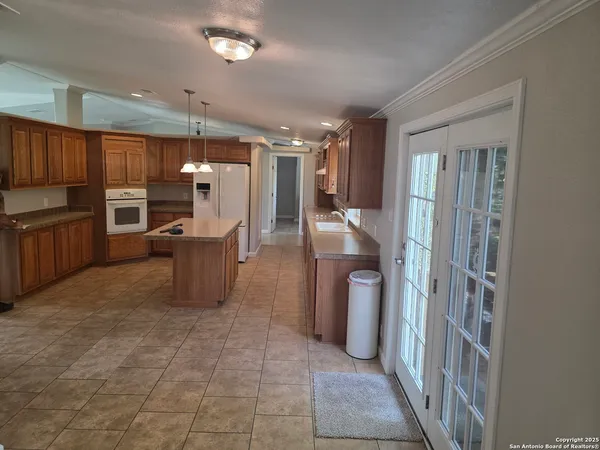 a view of a kitchen with furniture and windows