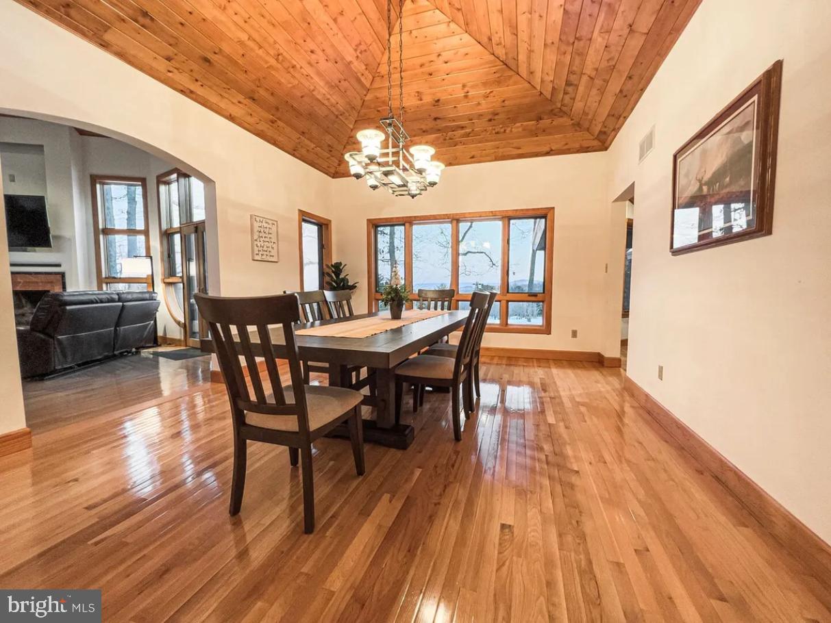349 Lucas Road Warfordsburg, PA 17267 - Photo 13 of 59 a view of a dining room with furniture a chandelier and wooden floor