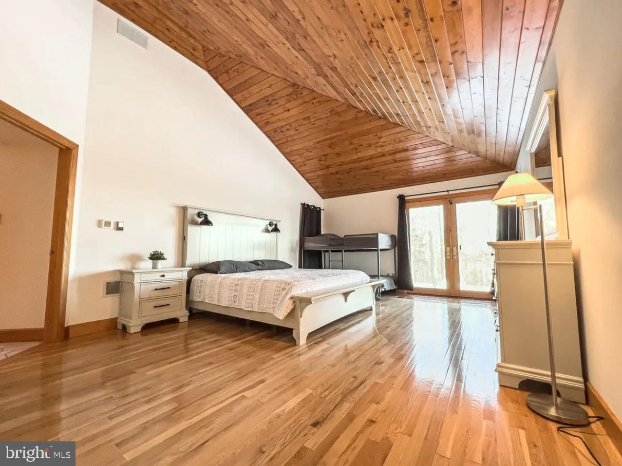 349 Lucas Road Warfordsburg, PA 17267 - Photo 22 of 59 a spacious bedroom with a bed and wooden floor