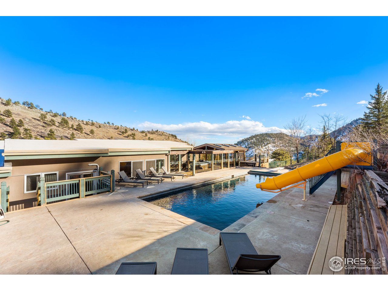 5339 Olde Stage Road Boulder, CO 80302 - Photo 39 of 40 A generous, well appointed oversized pool deck, surrounds this gorgeous in-ground pool, with automated pool cover, diving board and a gusher of a waterslide!