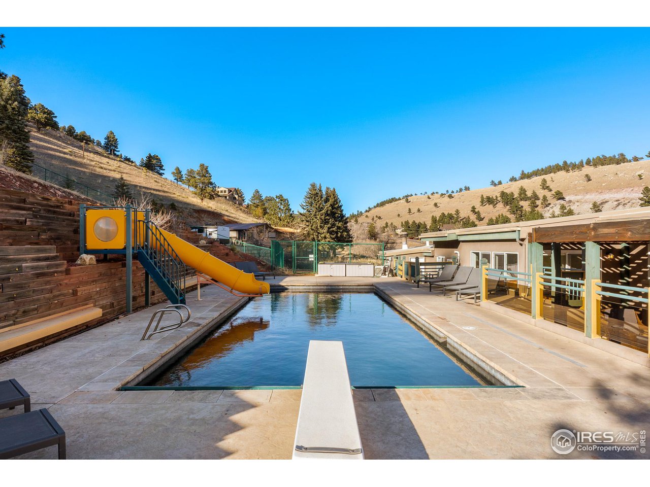 5339 Olde Stage Road Boulder, CO 80302 - Photo 5 of 40 A generous, well appointed oversized pool deck, surrounds this gorgeous in-ground pool, with automated pool cover, diving board and a gusher of a waterslide!