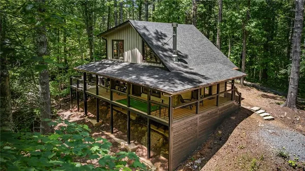 an aerial view of a house with balcony and outdoor space