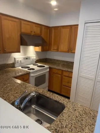 a kitchen with a stove a sink and a cabinets