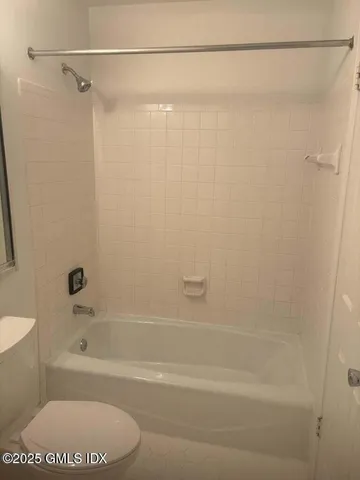 a bathroom with a shower and a bath tub