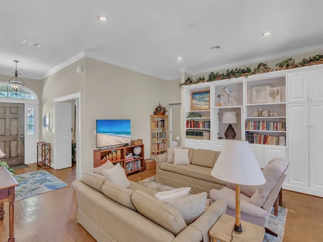 a living room with furniture and a book shelf
