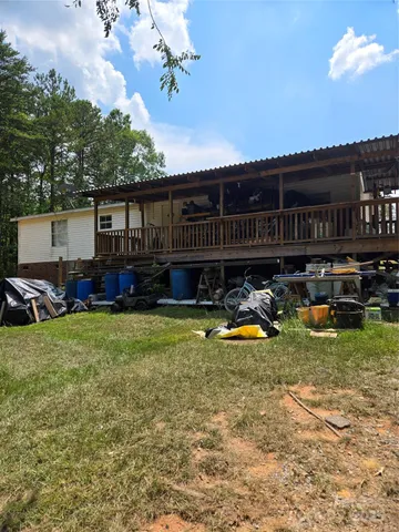 a view of a house with backyard tub and sitting area