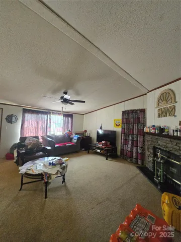 a living room with furniture a rug and a window