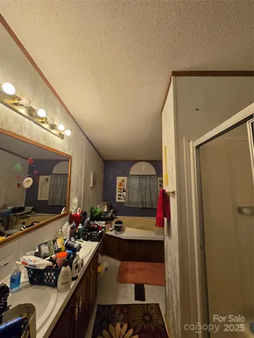 a room with furniture a flat screen tv and a sink