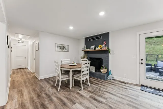 a dining room with furniture and wooden floor