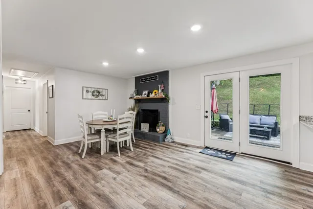 a dining room with furniture and wooden floor