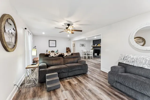 a living room with furniture a clock and a chandelier